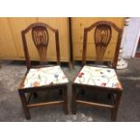 A pair of late eighteenth century country oak dowel jointed hall chairs, the arched backs with