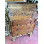 A small Edwardian mahogany bureau inlaid with chequered stringing, the fallfront enclosing