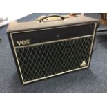 A Vox Celestion valve amplifier. (22.25in x 9in x 16.25in)