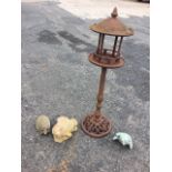 A novelty iron bird feeder with pagoda style enclosure on column, above domed pierced scrolled base;