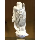 A reticulated porcelain oriental style fish on waved base - impressed marks. (9.5in)