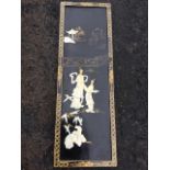A rectangular Japanese lacquer panel inlaid with a pair of geisha ladies on black garden ground, the