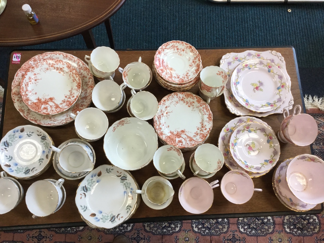 A late Victorian Balmoral China teaset decorated with orange foliate scrolling having gilt scalloped