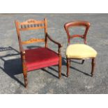 An Edwardian stained armchair, the back rails carved with floral roundels with a row of gallery