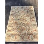 A thick pile contemporary floral wool rug woven in autumn colours. (72in x 49in)