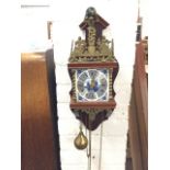 A delft wall clock with brass atlas figure above chime bell framed by pierced brass fretwork mounts,