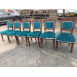 A set of six late Victorian mahogany dining chairs, the arched tapering backs carved with central