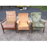 Two Parker Knoll upholstered armchairs with flared arms and loose cushions on rectangular tapering