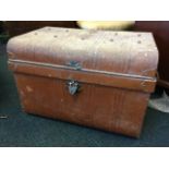 A scumbled tin trunk with ribbed hinged lid of studded construction, having carrying handles to