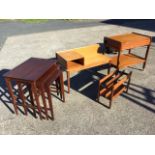 A teak trolley with tray platforms and a drawer; a teak telephone table or bench raised on square