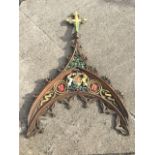A Victorian carved oak crest with crucifix above a triangular thistle panel, the arch with