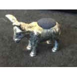 A novelty hallmarked silver pin cushion modelled as a donkey, his back with oval soft panel and head