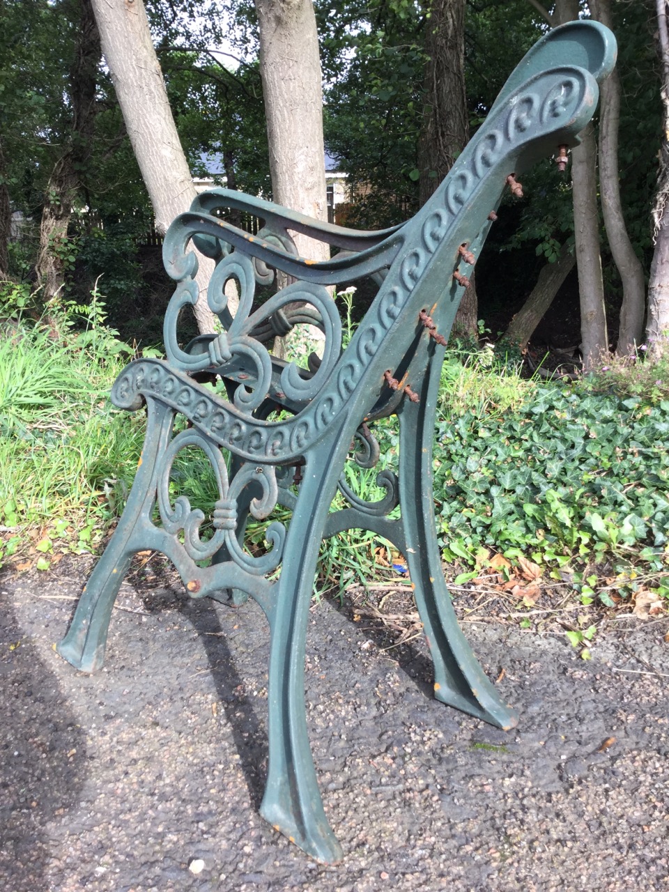 A pair of cast iron bench ends with pierced scrolled decoration on channelled sabre legs. (2) - Image 2 of 3