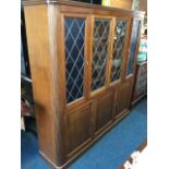 An Edwardian mahogany bookcase by Rutherfords of Newcastle upon Tyne, with moulded cornice above