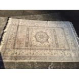 A pale oriental style Super Taj wool rug, woven with central star medallion in field flanked by
