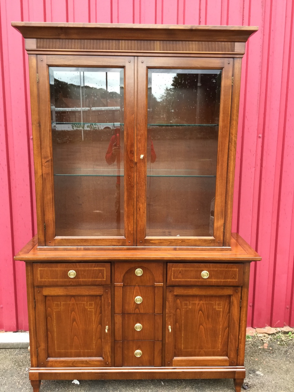 A reproduction mahogany cabinet, overall inlaid with chequered banding, having moulded cornice above