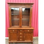 A reproduction mahogany cabinet, overall inlaid with chequered banding, having moulded cornice above