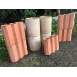 Four stoneware 9in chimney pipe liners; and five terracotta octagonal three-pipe drainers. (9)