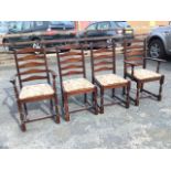 A set of four stained ladderback dining chairs with floral tapestry drop-in upholstered seats,
