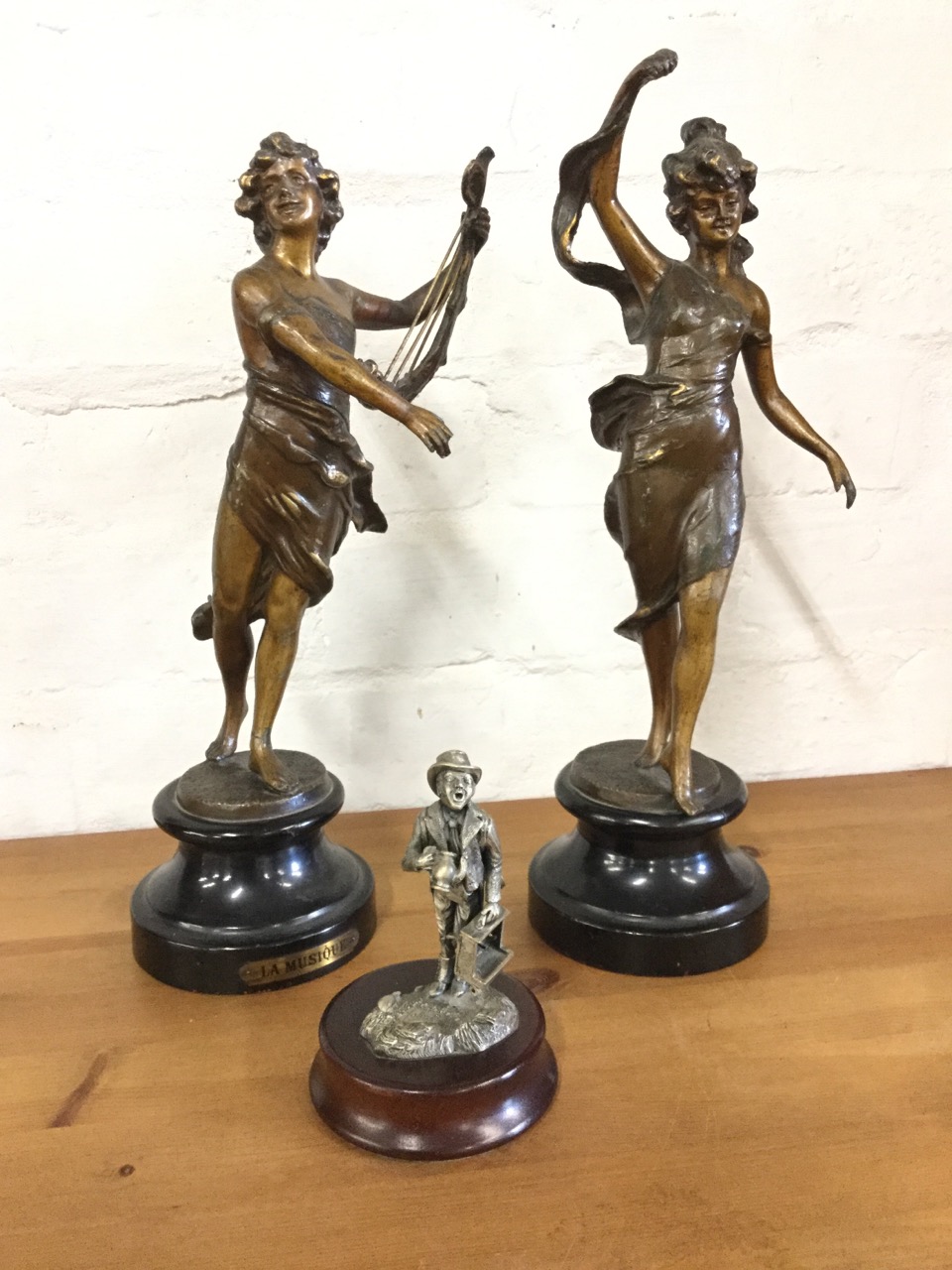 A pair of late nineteenth century French bronzed spelter figurines with draped dancing ladies on