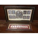 Two framed sets of eastern silver ingots, the embossed panels depicting classical scenes in titled