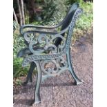 A pair of cast iron bench ends with pierced scrolled decoration on channelled sabre legs. (2)