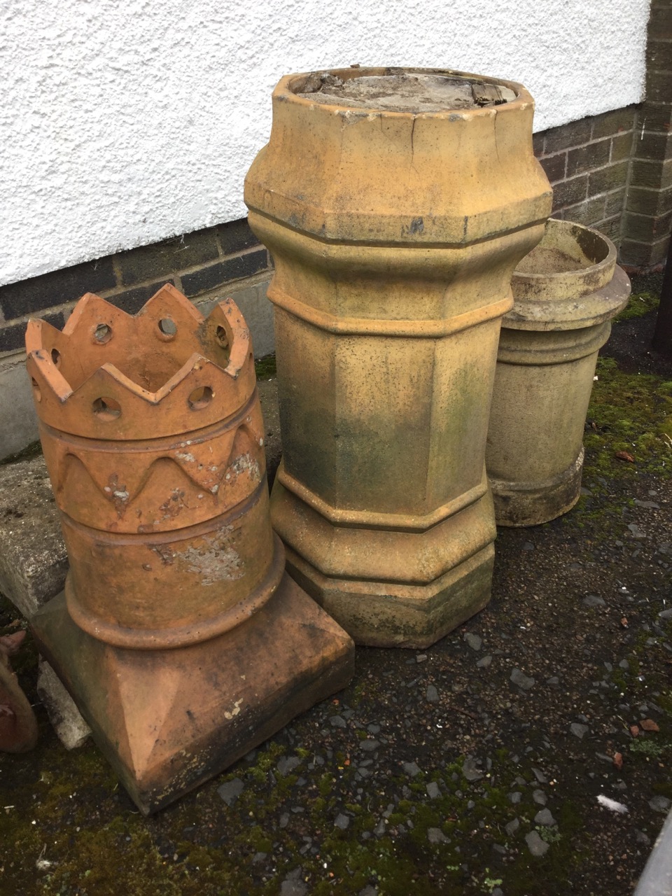 Three Victorian chimney pots - tall octagonal stoneware with moulded plinth & rim tubular on