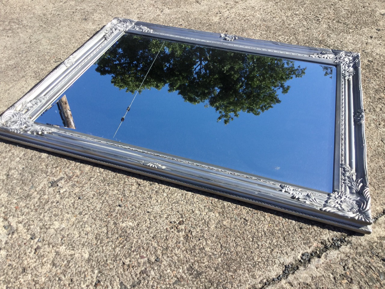 A modern rectangular mirror with bevelled plate in foliate moulded silvered frame. (36.75in x 28. - Image 2 of 3