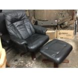 A contemporary black leather reclining armchair with matching footstool, the panelled upholstered