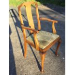 A Queen Anne style armchair with rectangular splat and shaped arms above a drop-in upholstered seat,