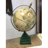 A Replogle 9in diameter globe, the world with brass mounts on square faux malachite stepped
