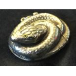 A Sterling silver novelty vesta case modelled as a coiled snake with inlaid eyes, having sprung