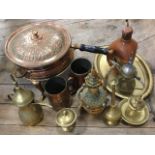 An eastern embossed copper cooking pot with pans on stand with burner; a pair of copper tankards