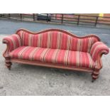 A Victorian mahogany camelback sofa, the moulded frame with acanthus scroll carved arms above an