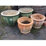 A pair of green glazed stoneware garden tubs with flat rims; and a pair of fluted terracotta