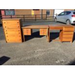 A 60s teak chest of six drawers mounted with shaped handles; a 60s teak kneehole dressing table