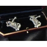 A cased pair of silver cufflinks modelled as Michelin men, with short chains and T bars - Sterling