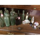Sixteen old 'dug-up' type bottles; a glass beetle car, and four glass-type paperweights; and a