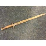 A Second World War bayonet, with tapering channelled blade and hardwood sprung handle - various