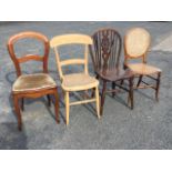 Four miscellaneous chairs - an elm wheelback, a cane seated balloon back on turned legs, a