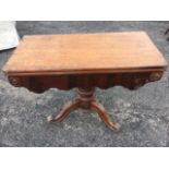 A Victorian mahogany turn-over-top tea table, the rounded twin top above a shaped apron with applied
