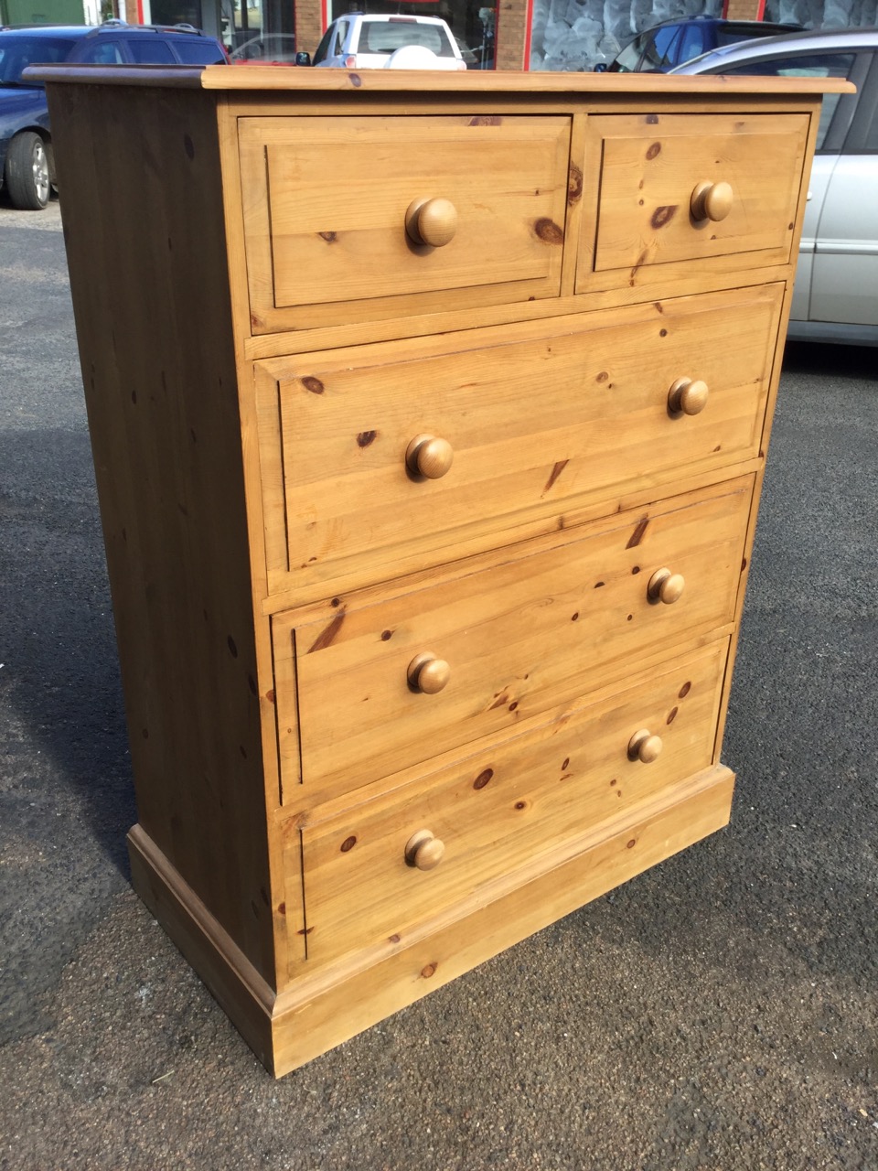 A Victorian style pine chest of drawers, with rectangular moulded top above two short and three long