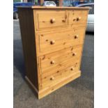 A Victorian style pine chest of drawers, with rectangular moulded top above two short and three long