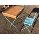 A childs folding desk & chair, on painted tubular metal frames. (2)