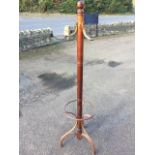 A mahogany coatstand, the ring turned column with knob finial mounted with pegs, on bentwood