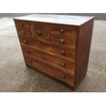 A nineteenth century mahogany chest of drawers, the central drawer with oval inlaid panel flanked by