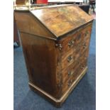 A nineteenth century Queen Anne style walnut bureau, the top with brass rail above a fallfront