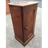 A late Victorian mahogany pot cupboard with chamfered panelled door enclosing shelf, raised on