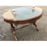 A Victorian walnut marquetry desk, the oval scalloped top with scrolled foliate inlay set with two