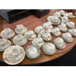 An Austrian porcelain 12-piece floral teaset decorated with green lustre borders; a Tuscan 6-piece